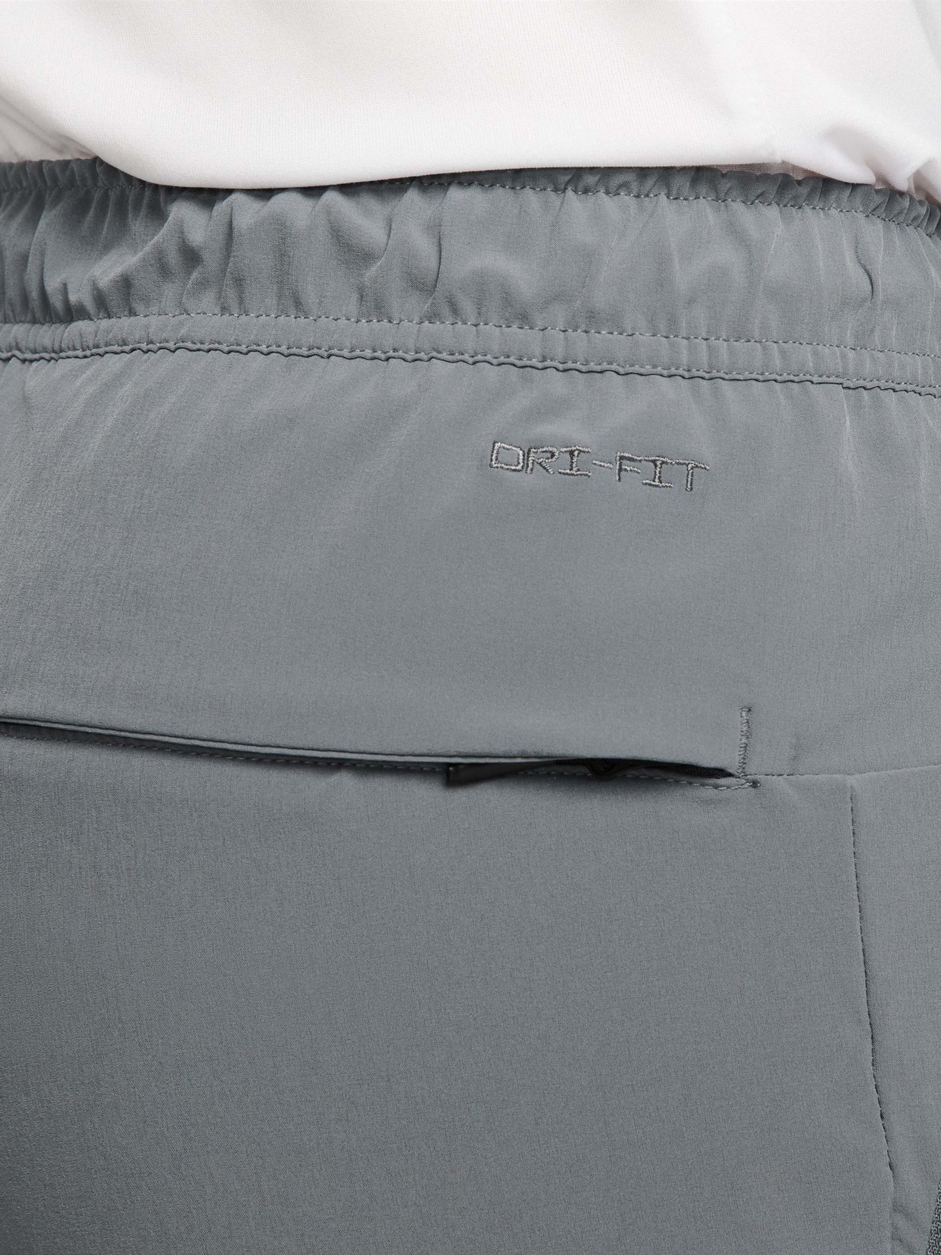 Штани NIKE DRI-FIT UNLIMITED TAPERED LEG модель FB7548-084 Фото