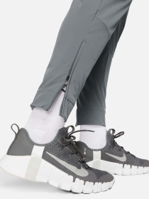 Штани NIKE DRI-FIT UNLIMITED TAPERED LEG модель FB7548-084 Фото